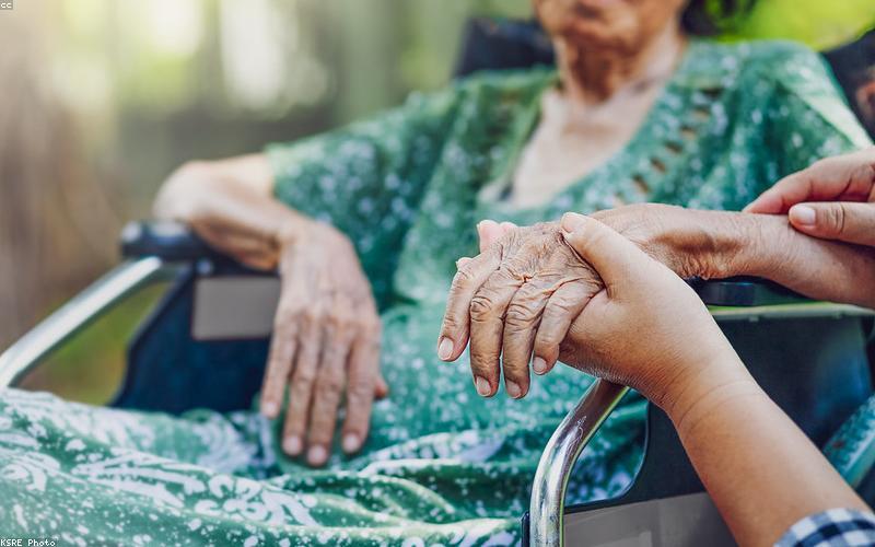 Caregiver assisting elderly parent